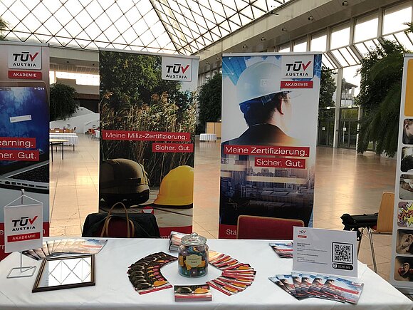 Lächelnde Dame am TÜV AUSTRIA Akademie Stand.